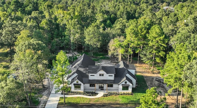 drone / aerial view with a wooded view