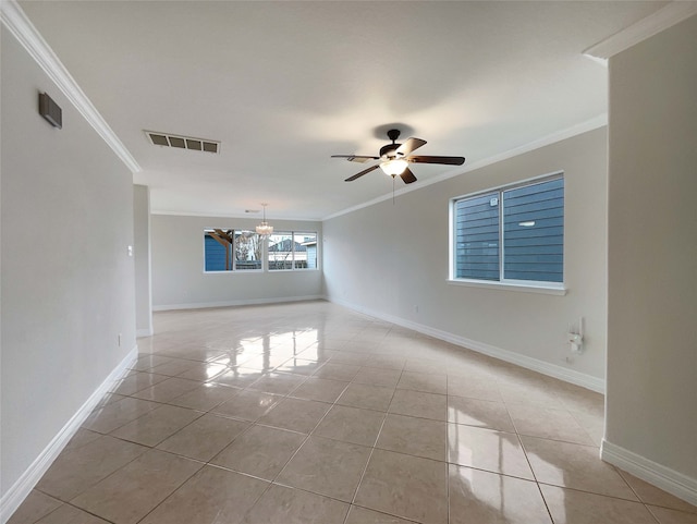 tiled spare room featuring ornamental molding and ceiling fan with notable chandelier