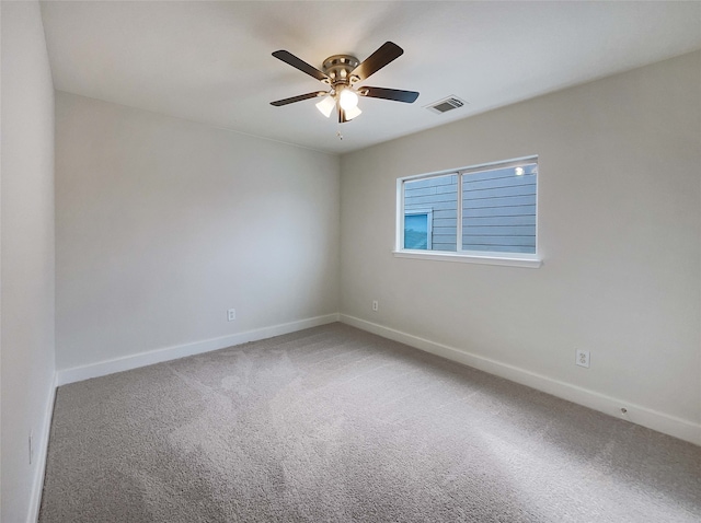 carpeted empty room featuring ceiling fan