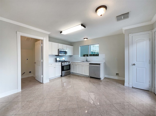 kitchen with white cabinetry, sink, light tile patterned floors, and stainless steel appliances