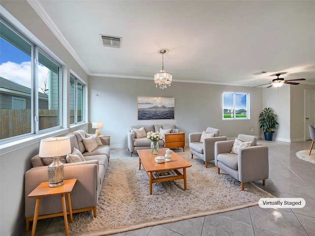 living room featuring light tile patterned flooring, ornamental molding, and ceiling fan with notable chandelier