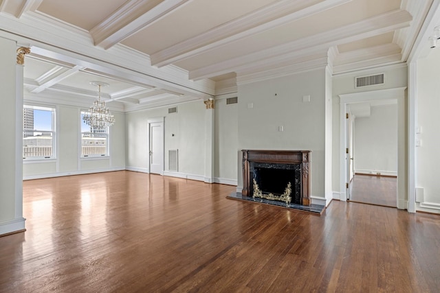 unfurnished living room with beam ceiling, ornamental molding, hardwood / wood-style floors, and a fireplace