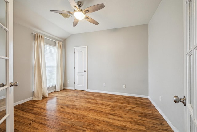 unfurnished bedroom featuring lofted ceiling, hardwood / wood-style floors, french doors, and ceiling fan