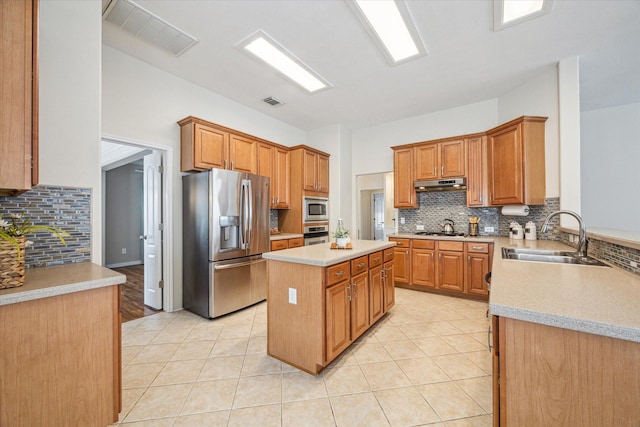 kitchen with stainless steel appliances, a center island, sink, and light tile patterned floors