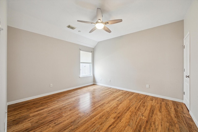 spare room featuring lofted ceiling, hardwood / wood-style floors, and ceiling fan