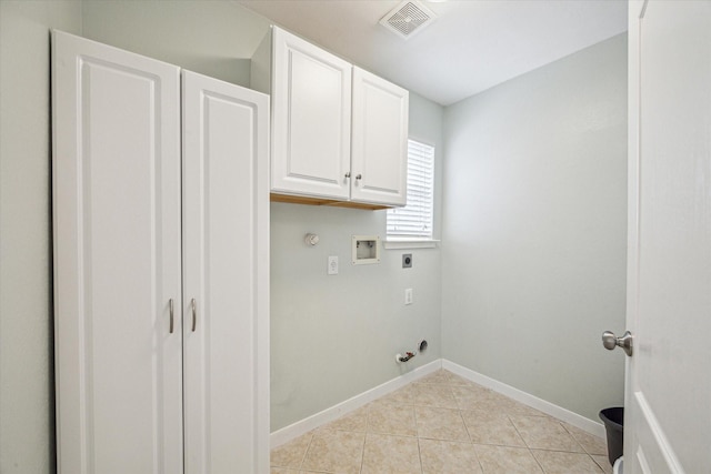 laundry room featuring light tile patterned flooring, gas dryer hookup, cabinets, washer hookup, and hookup for an electric dryer