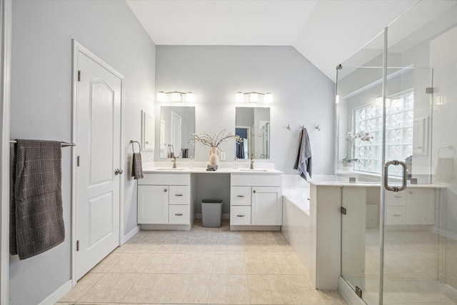 bathroom with shower with separate bathtub, lofted ceiling, vanity, and tile patterned floors