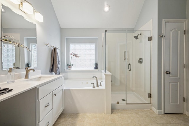 bathroom with tile patterned floors, shower with separate bathtub, vaulted ceiling, and vanity