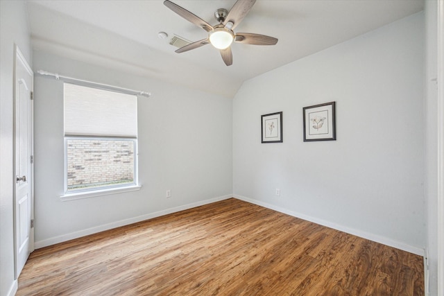 spare room with vaulted ceiling, ceiling fan, and light wood-type flooring