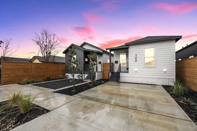 view of front of house featuring fence
