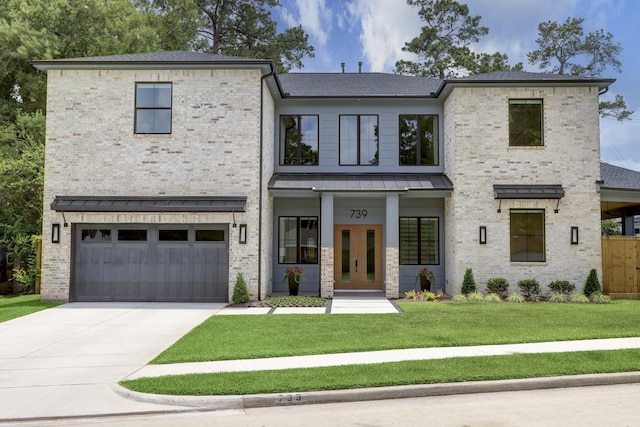 view of front of house with a garage and a front lawn