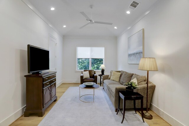 living room featuring light hardwood / wood-style floors and ceiling fan