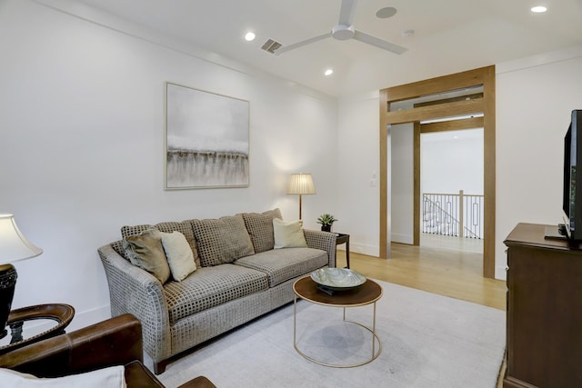 living room with ceiling fan and light wood-type flooring