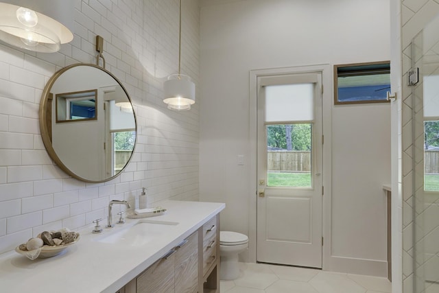 bathroom featuring tile walls, backsplash, tile patterned flooring, vanity, and toilet