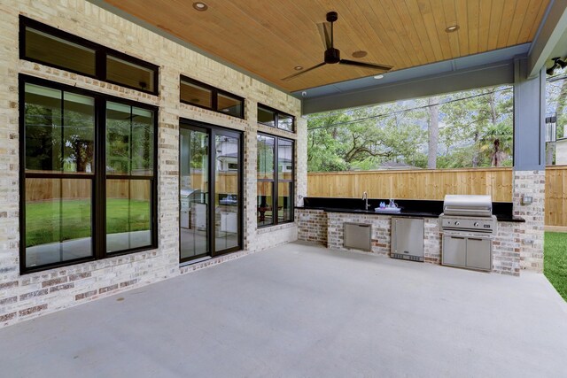 view of patio / terrace with grilling area, an outdoor kitchen, sink, and ceiling fan