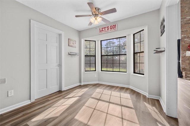 unfurnished room with light hardwood / wood-style floors and ceiling fan