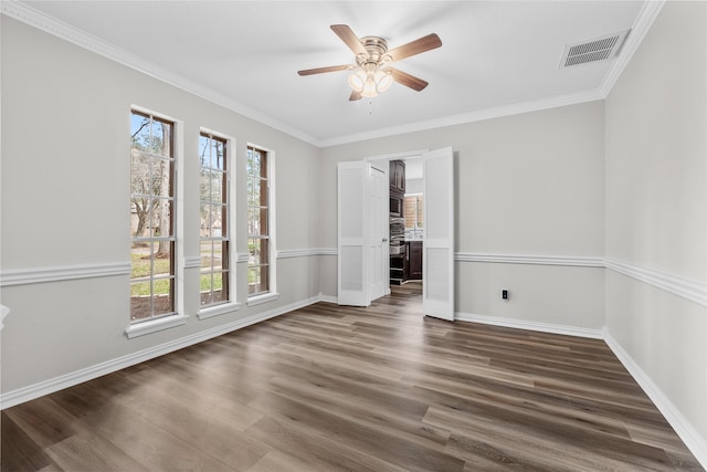 empty room with ornamental molding, dark hardwood / wood-style floors, and ceiling fan