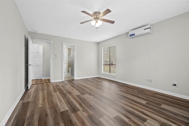 empty room featuring ceiling fan, dark hardwood / wood-style floors, and an AC wall unit