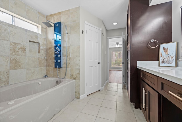 bathroom with vanity, ceiling fan, tile patterned floors, and tiled shower / bath