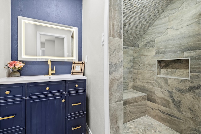 bathroom featuring vanity and a tile shower