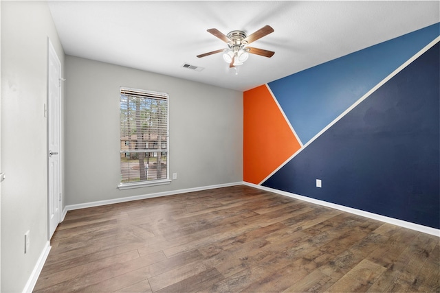 spare room featuring hardwood / wood-style flooring and ceiling fan