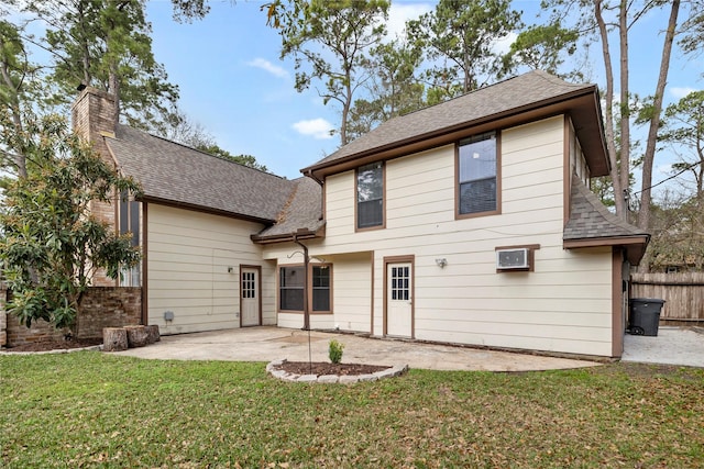 back of house featuring a patio area and a lawn