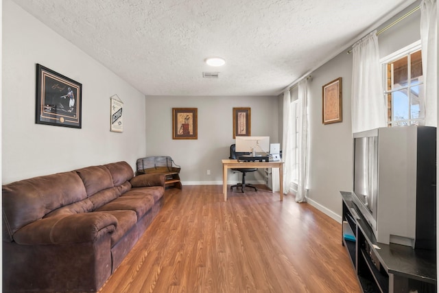 living room featuring hardwood / wood-style flooring and a textured ceiling