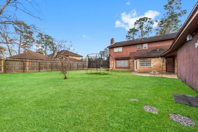 view of yard featuring a patio and a trampoline