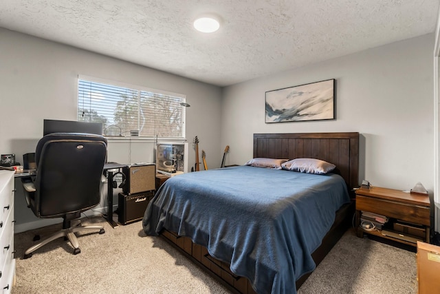 bedroom with light colored carpet and a textured ceiling