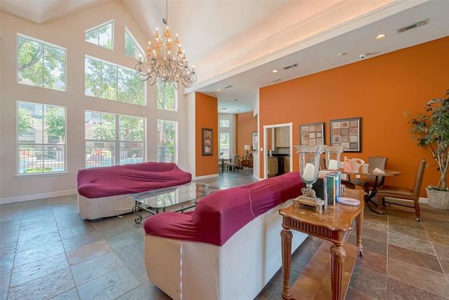 living room with a chandelier and a high ceiling