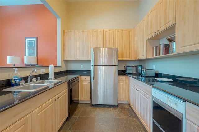 kitchen with dishwasher, sink, stainless steel fridge, and light brown cabinetry