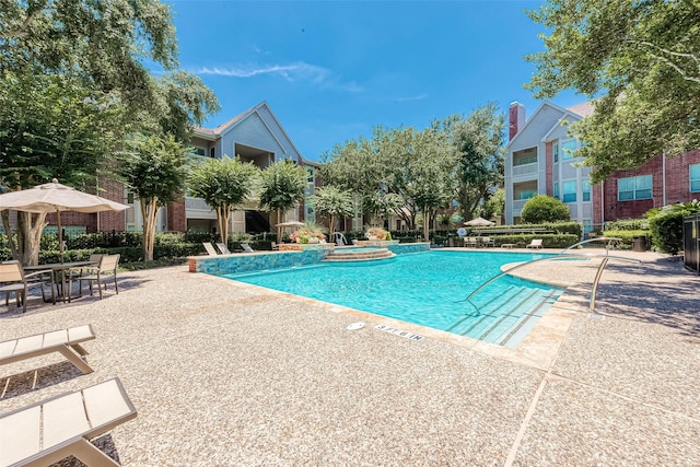 view of pool with a community hot tub and a patio area