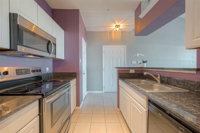 kitchen with white cabinetry, sink, stainless steel appliances, and light tile patterned flooring