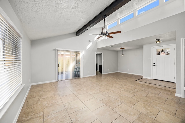 unfurnished living room with ceiling fan, light tile patterned floors, a textured ceiling, and vaulted ceiling with beams