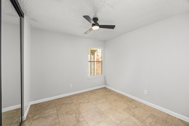 unfurnished room featuring a textured ceiling and ceiling fan