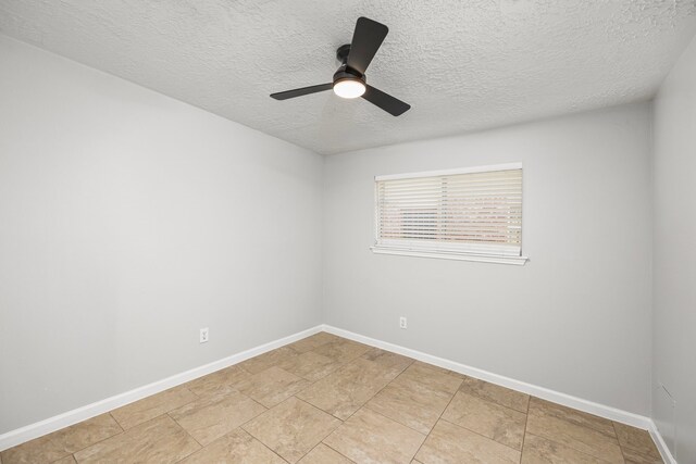 unfurnished room featuring ceiling fan and a textured ceiling