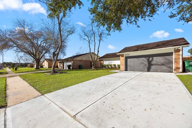 single story home featuring a garage and a front lawn