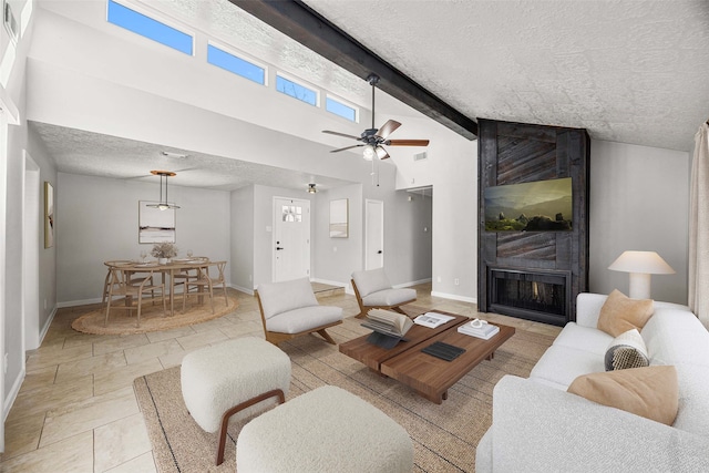 living room with high vaulted ceiling, a textured ceiling, a large fireplace, ceiling fan, and beam ceiling