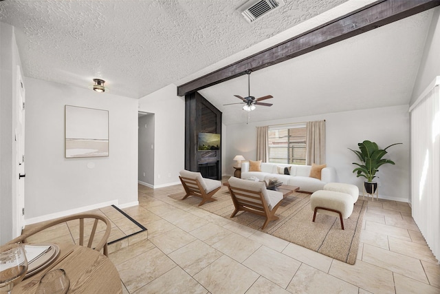 living room with lofted ceiling with beams, light tile patterned flooring, a textured ceiling, and ceiling fan