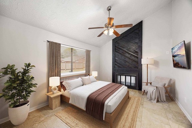 bedroom featuring vaulted ceiling, a multi sided fireplace, a textured ceiling, and light tile patterned flooring