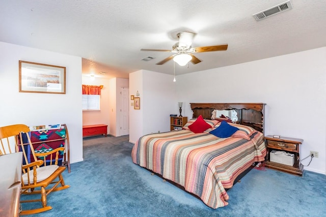 bedroom featuring ceiling fan, a textured ceiling, and carpet flooring