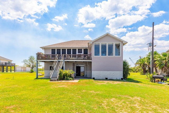 rear view of house with a wooden deck, a yard, and a sunroom