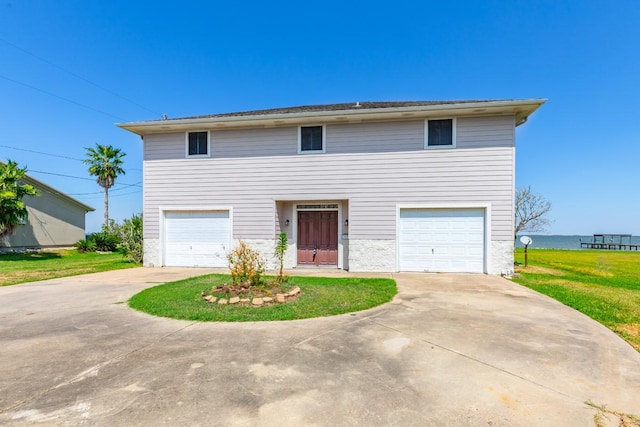 view of front facade with a garage and a front lawn