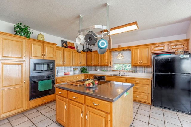 kitchen featuring a kitchen island, sink, light tile patterned floors, and black appliances