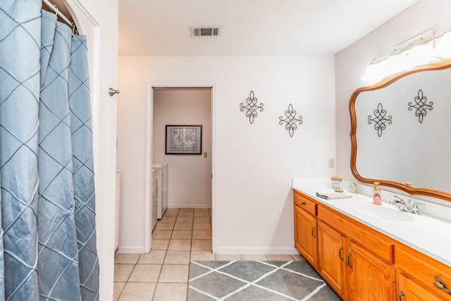 bathroom with a shower with shower curtain, vanity, and tile patterned flooring