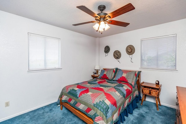 carpeted bedroom featuring ceiling fan and a textured ceiling