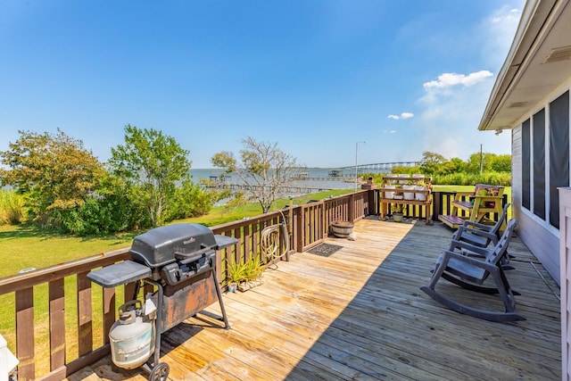 deck featuring a grill and a water view