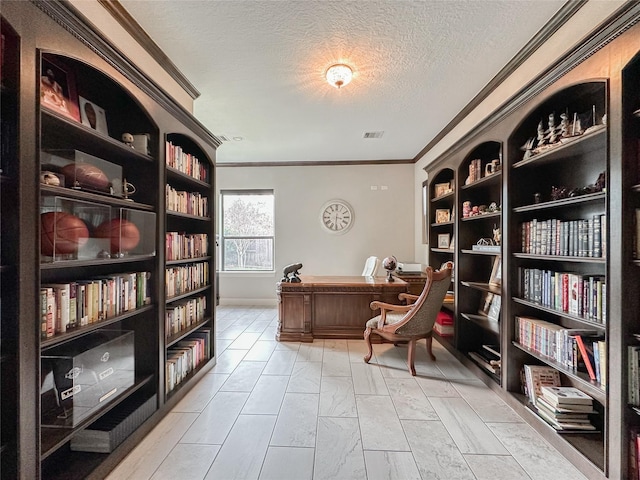 office space featuring ornamental molding, a textured ceiling, and built in shelves