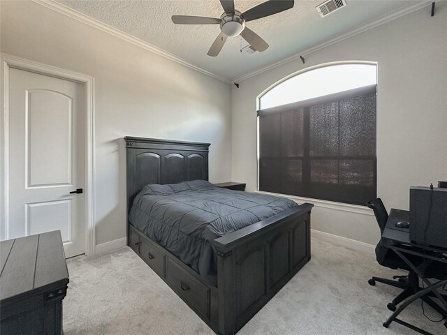 carpeted bedroom with crown molding, ceiling fan, and a textured ceiling