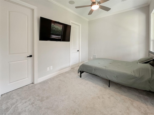 carpeted bedroom featuring crown molding and ceiling fan